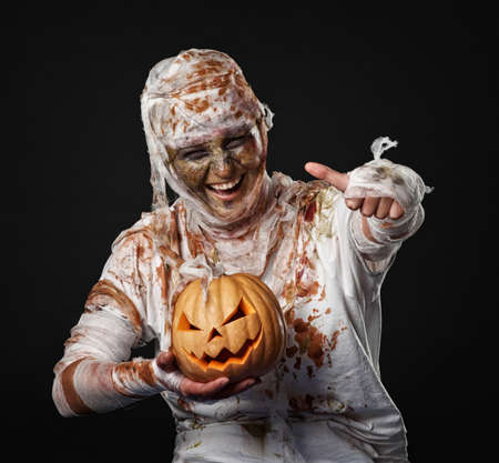 The mummy is thumbup in the studio with pumpkinの写真素材