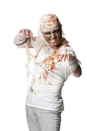 scary zombie or mummy waves his arms isolated