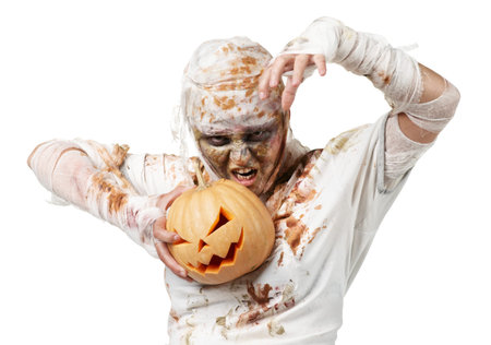 Evil mummy is holding  pumpkin in the studio