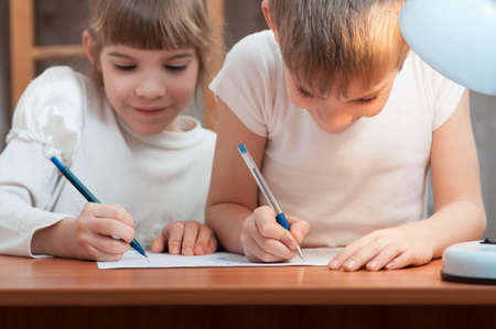 children draw at the table in the lamplightの写真素材