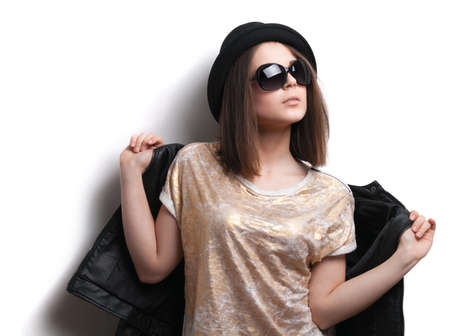 Caucasian girl in a leather jacket and a black hatの写真素材