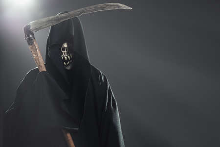 death with scythe standing in the darkの写真素材