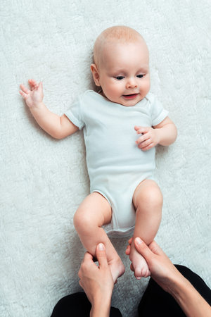 Little baby with mum is making massageの写真素材