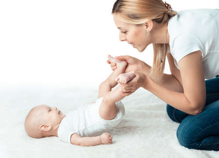 Little baby with mum is making massageのeditorial素材