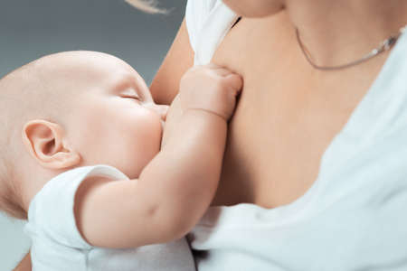Baby feeds on MOM's breastsのeditorial素材