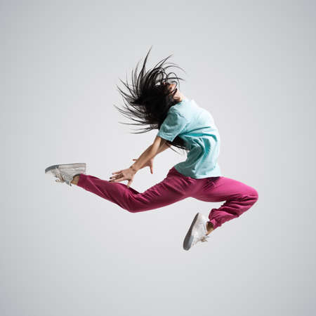 beautiful athletic girl dancing jumpingの写真素材