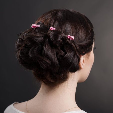 hairstyles brunette girl in studio on a gray background