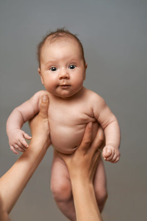 one month old baby boy in the comfort of moms arms