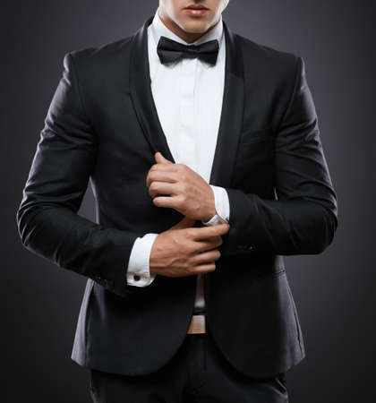 handsome business man in suit on a dark backgroundの写真素材