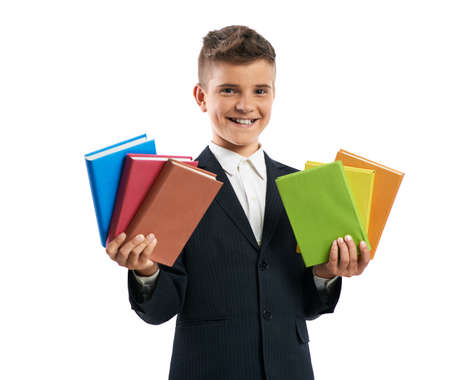 student shows a lot of textbooks in both hands isolatedの写真素材