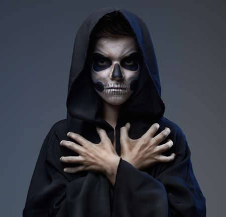 Teen with makeup closed skull scary handsの写真素材