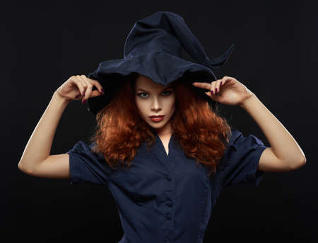 beautiful red-haired girl in a blue costume witchの写真素材