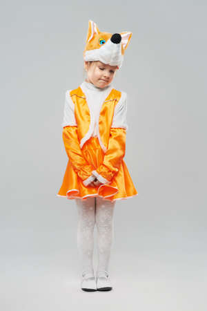 Cute shy red-haired girl in a suit of chanterellesの写真素材