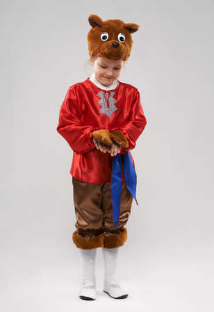 Cute shy redhead girl in a suit of the Slavic bearの写真素材