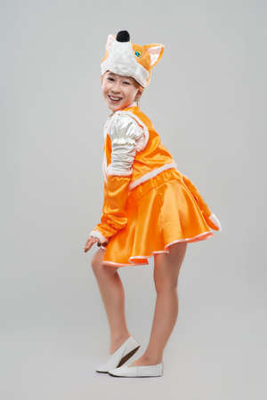 Cheerful red-haired girl in a suit of foxの写真素材