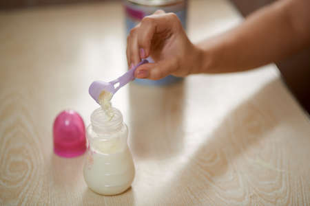 kneading artificial feed for a babyの写真素材