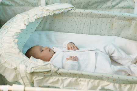 cute little baby sleeping in the mangerの写真素材