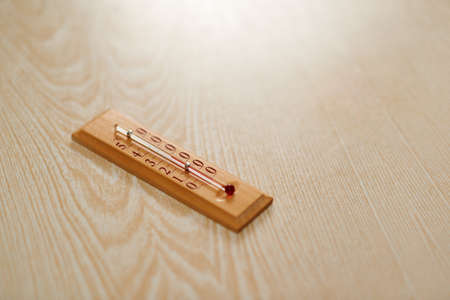 Wooden thermometer with Celsius scale on the tableの写真素材