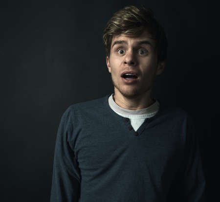 very scared guy in the darkの写真素材