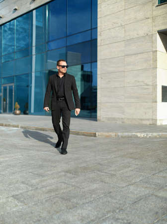businessman walking on the street near the officeの写真素材
