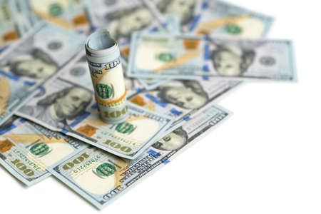 bundle of dollars on bills spillingの写真素材