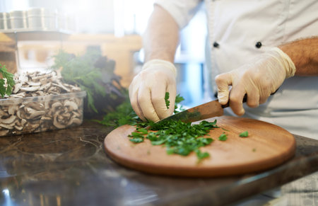 Chef wearing gloves cut greens