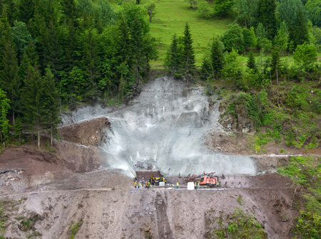 Many people works near the green slopeの写真素材