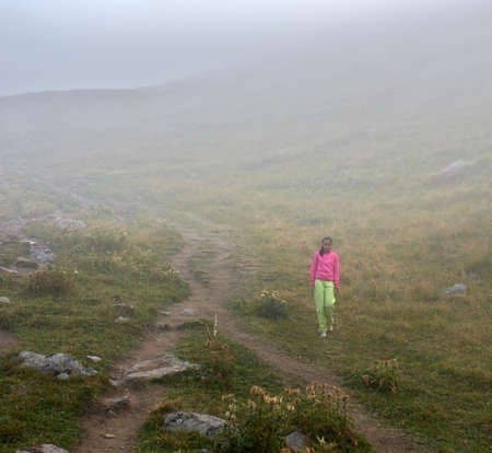 There is a girl in the autumn fogの写真素材