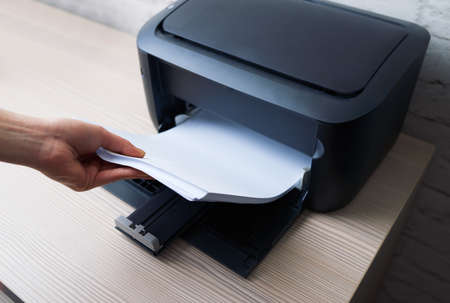 lay down or take the paper from  printerの写真素材