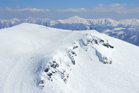 Alpine ski resort slopes from afar, in the afternoon.の写真素材