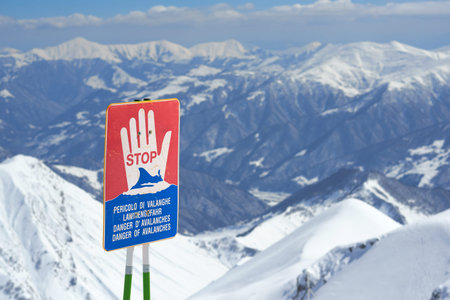 warning signs of avalanche on the slopes of the mountain in winterの写真素材