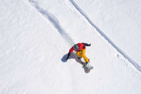 Snowboarder riding on loose snow Freeride top view.の写真素材