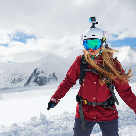 Snowboarder girl in a red jacketの写真素材