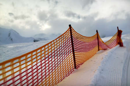 muzzle red grid on a ski slope in the evening.の写真素材