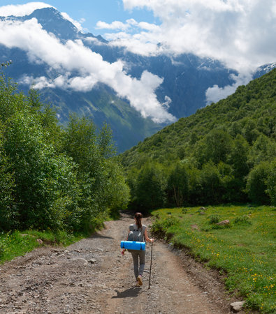she descends from the mountain on a forest path