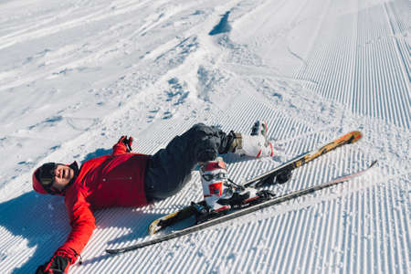 competitor fell while skiing and laughing.の写真素材