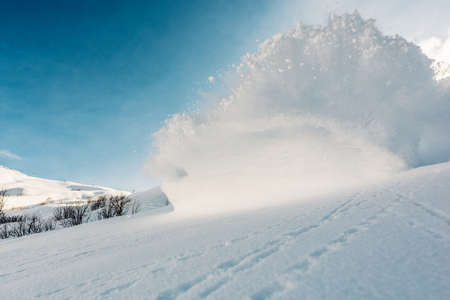 Big snow explosion on the mountain hillの写真素材