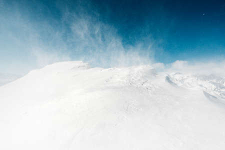 beautiful snow view with snowstorm in the mountainの写真素材
