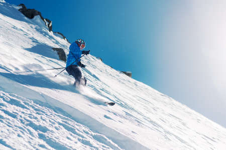girl with special ski equipment is riding fast, jumping, freeriding very fast in the mountain forestの写真素材