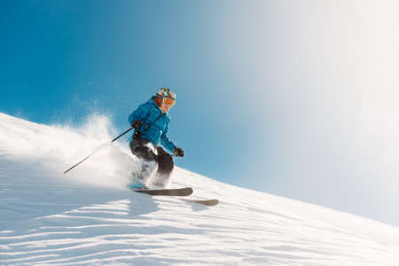 girl with special ski equipment is riding fast, jumping, freeriding very fast in the mountain forestの写真素材