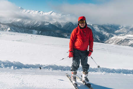 man with special ski equipment is riding fast, jumping, freeriding very fast in the mountain forestの写真素材