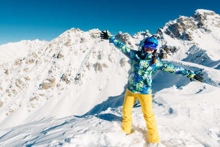woman is dancing in the yellow trousers in the mountainの写真素材