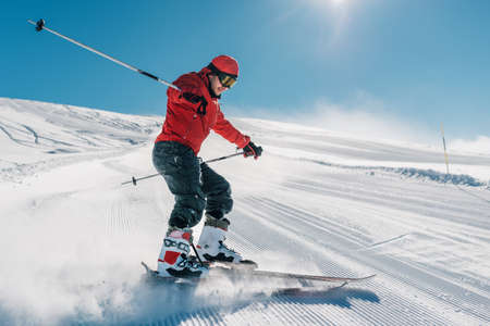 man with special ski equipment is riding fast, jumping, freeriding very fast in the mountain forestの写真素材