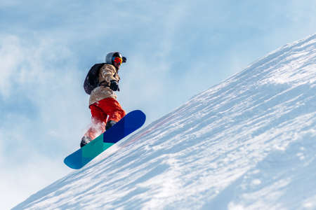 man with special ski equipment is riding fast, jumping, freeriding very fast in the mountain forestの写真素材
