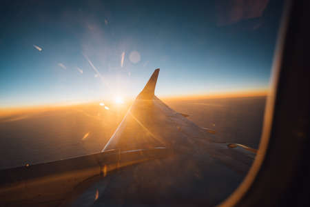 Beautiful view from plane window to the clouds and plane wingの写真素材