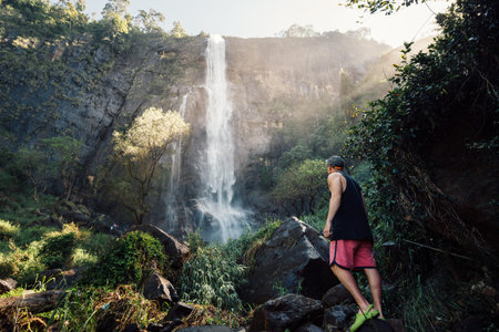 Man go to the waterfall in the shrilanka forest