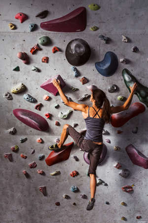 girl is climbing in the training roomの写真素材