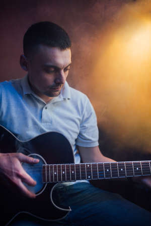funny guy plays guitar in smoke roomの写真素材
