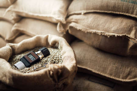 a working device for measuring the humidity of coffee beans in a bag , in the backgroundの写真素材