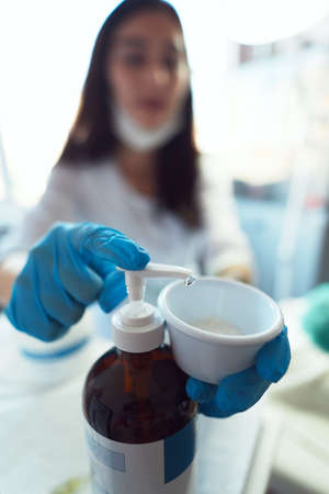 The beautician makes an enzyme peeling at the clients request.の写真素材